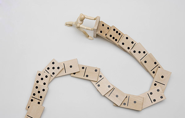 social media (image: figurine pushing string of dominos down)