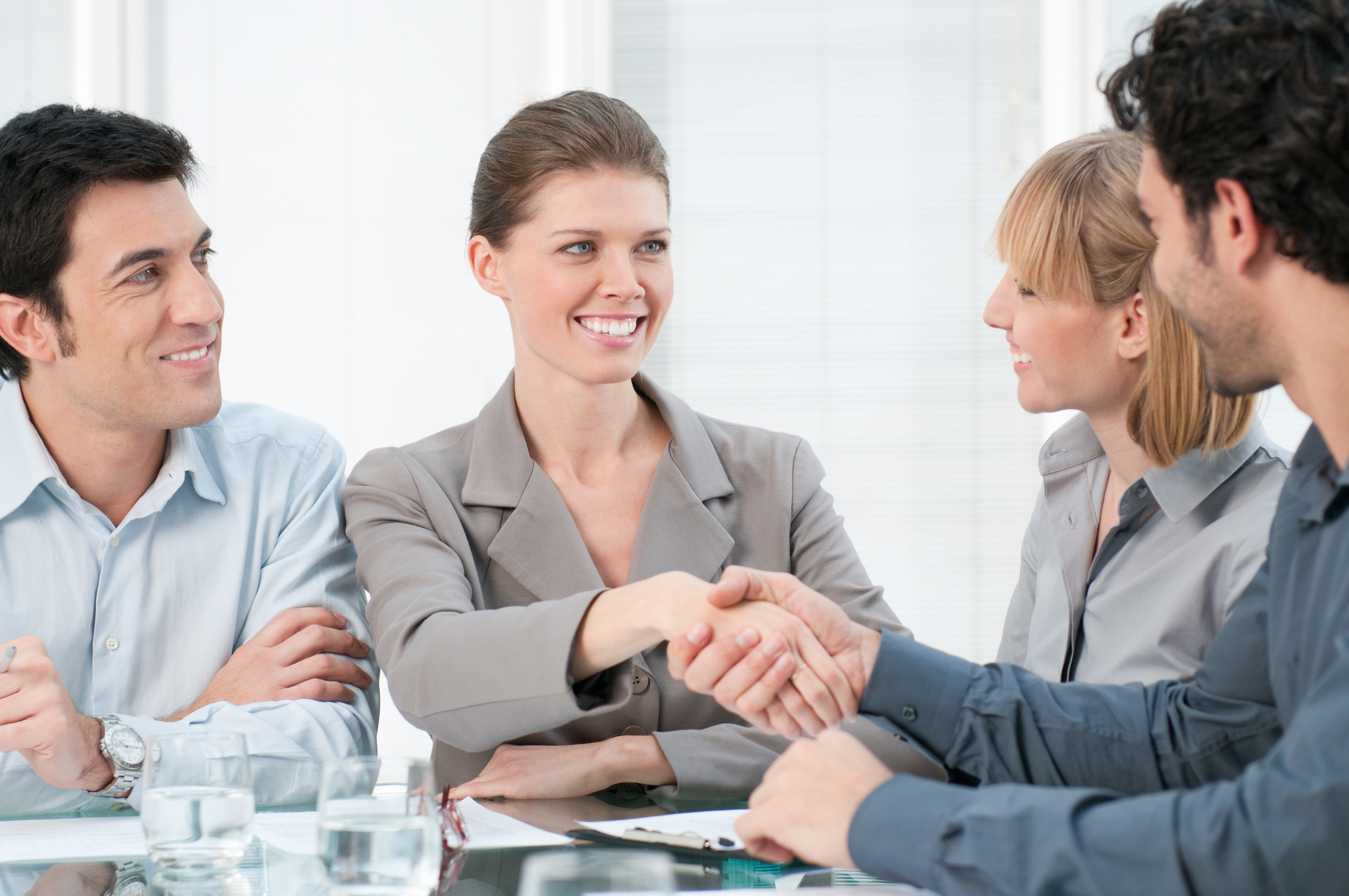 Referral marketing (Image: Happy smiling businesswoman shaking hands after a business meeting)