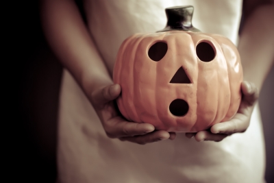 holiday marketing (image: woman holding jack-o-lantern ceramic sculpture)