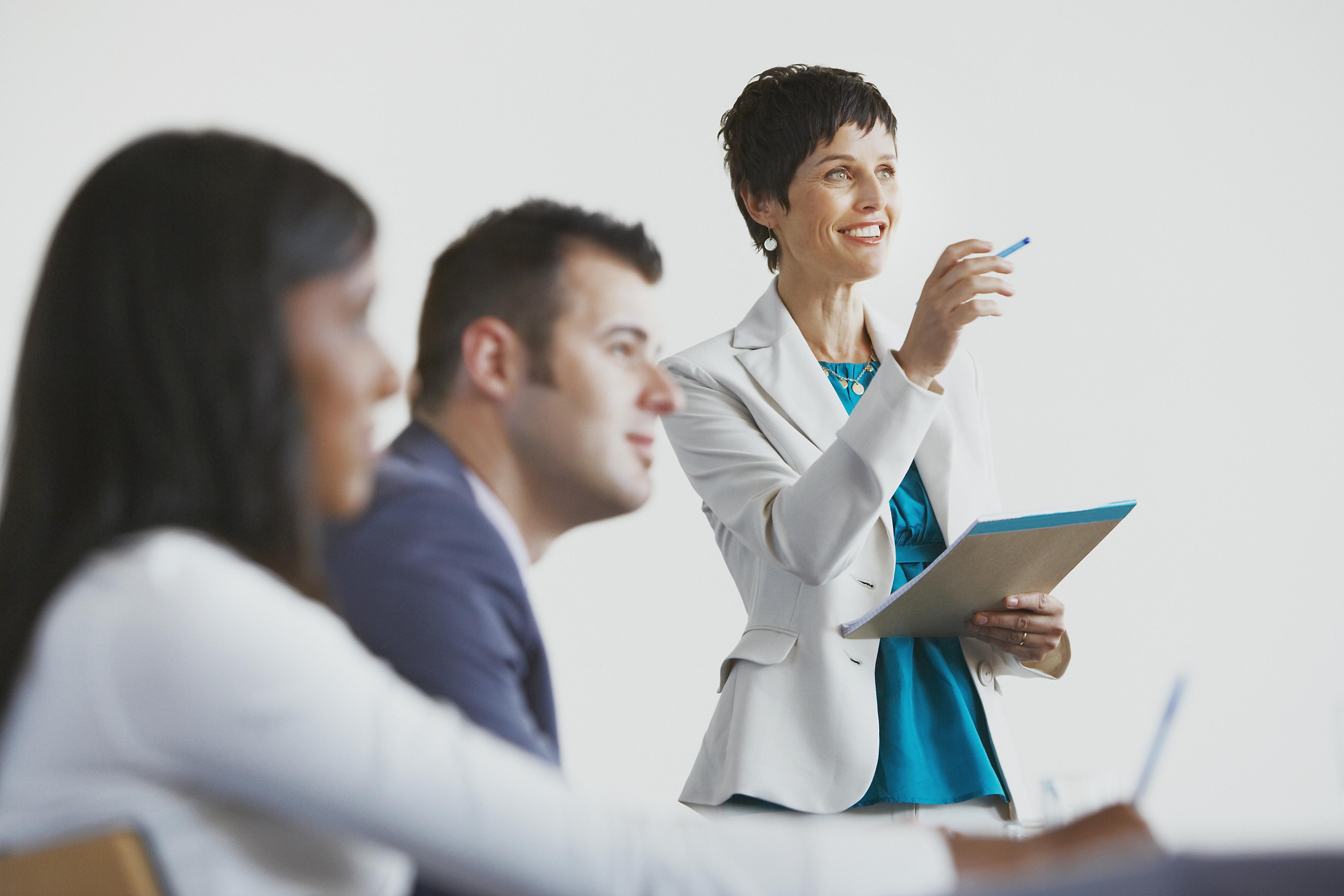 referral generation (image: woman presenting to group)